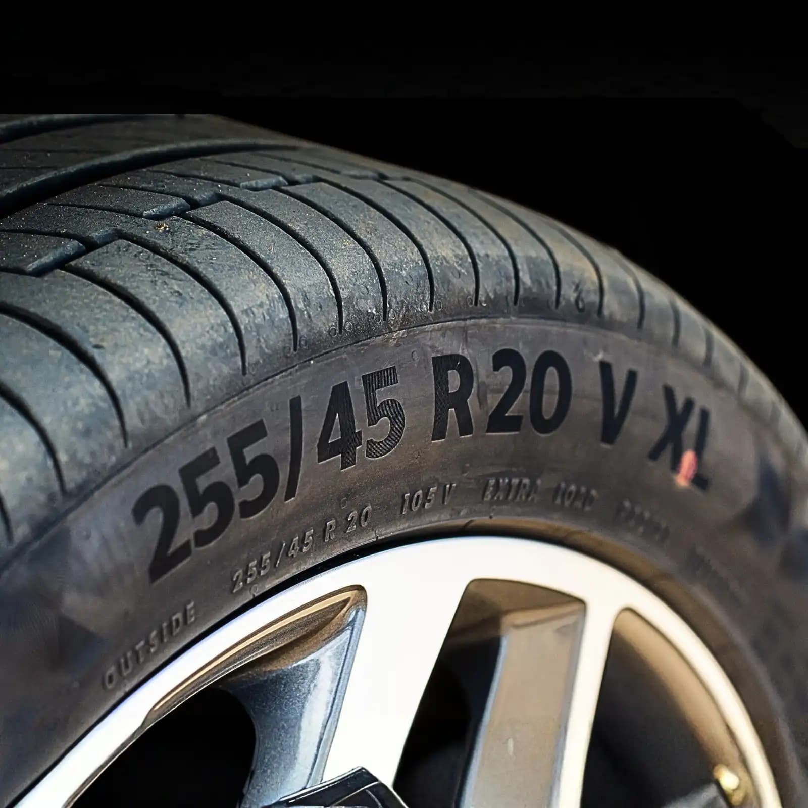 Close-up of a tire sidewall showing its 255/45 R20 size marking